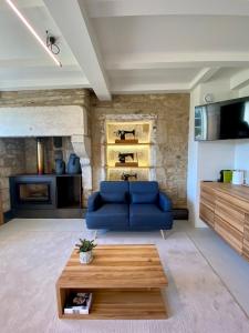 a living room with a blue couch and a table at The Tailor's Garden in Santiago de Compostela