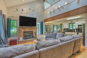 a large living room with a large couch and a fireplace at Poconos Gem Fire Pit, Hot Tub, Community Pool in East Stroudsburg