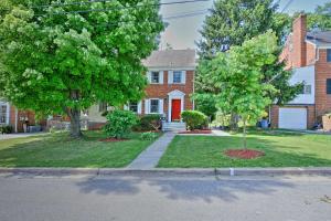 a house with a red door and two trees at Vibrant Hyattsville Home 7 Mi to Downtown DC! in Hyattsville