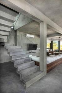 a concrete staircase in a room with a couch at Casa Gonza Holbox in Holbox Island