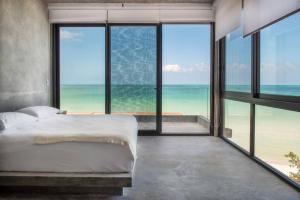 a bedroom with a bed and a view of the ocean at Casa Gonza Holbox in Holbox Island