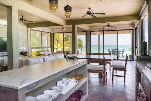 a kitchen and dining room with a view of the ocean at Casa Gonza Holbox in Holbox Island