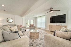 a living room with two couches and a flat screen tv at Cherokee Lake Home with Private Dock and Patio! in Bean Station