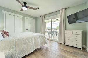 a bedroom with a bed and a television and a table at Cherokee Lake Home with Private Dock and Patio! in Bean Station