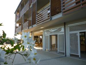 a building with white flowers in front of it at Elaia Garden Hotel in Sperlonga