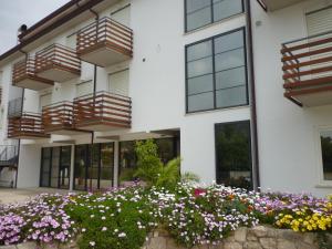 a building with flowers in front of it at Elaia Garden Hotel in Sperlonga