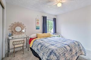 a bedroom with a bed and a mirror and a table at Bryan Home with Deck and Yard about 4 Mi to Texas A and M! in Bryan