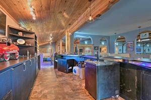 a bar with blue cabinets and a red car on the counter at Massive Hatfield Loon Lodge with Roller Rink in Hatfield