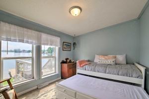 a bedroom with a bed and a large window at Waterfront Michigan Center Home with Boat Dock! in Jackson +32 photos