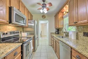 a kitchen with wooden cabinets and stainless steel appliances at Pet-Friendly Home Close to WEC Ocala! in Ocala