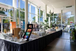 a long table with food on it in a building at ATLANTIC Hotel Galopprennbahn in Bremen
