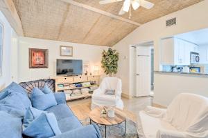 a living room with a blue couch and chairs at Heated Saltwater Pool and Bar Del Ray Cottage! in Delray Beach
