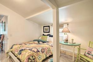 a bedroom with a bed and a table at Heated Saltwater Pool and Bar Del Ray Cottage! in Delray Beach +18 photos