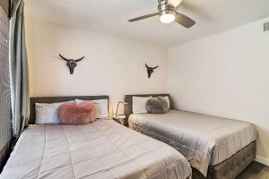 a bedroom with two beds with antlers on the wall at Furnished Patio and Mtn View Palm Desert Retreat in Palm Desert +40 photos