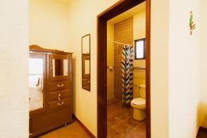 a bathroom with a toilet and a sink and a mirror at Rancho San Pablo in Oaxaca City