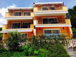 a yellow building with balconies on the side of it at Studio Icici 7785a in Ičići