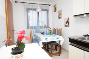 a small kitchen with a table and a sink at Apartments with WiFi Lovran, Opatija - 7886 in Lovran