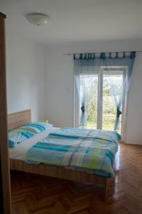 a bedroom with a bed and a large window at Apartments with a parking space Opric, Opatija - 7726 in Opric