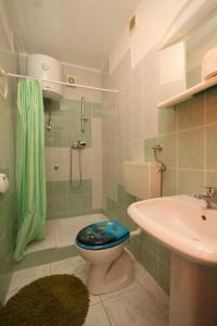 a bathroom with a toilet and a sink at Apartments with a parking space Opric, Opatija - 7726 in Opric