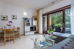 a living room with a couch and a table at Apartments with parking space Medulin - 7657 in Medulin