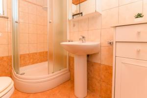 a bathroom with a sink and a shower at Apartments by the sea Nerezine, Losinj - 7963 in Nerezine