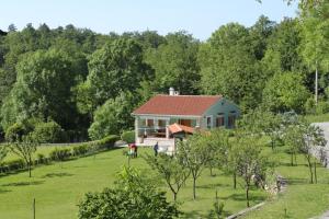 a house in the middle of a field with trees at Holiday house with a parking space Veprinac, Opatija - 7699 in Veprinac