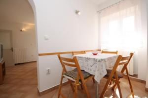 a dining room with a table and chairs at Holiday house with a parking space Veprinac, Opatija - 7699 in Veprinac