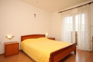 a bedroom with a bed and a cross on the wall at Apartments with a parking space Cres - 7994 in Cres