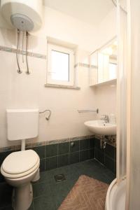 a bathroom with a toilet and a sink at Apartments with a parking space Cres - 7994 in Cres