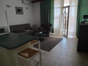 a living room with a couch and a table at Apartments by the sea Medveja, Opatija - 7722 in Lovran