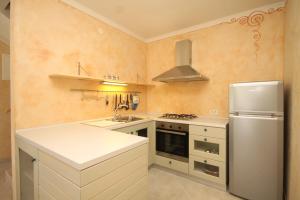 a kitchen with a sink and a refrigerator at Holiday house with a parking space Nerezine, Losinj - 8016 in Nerezine