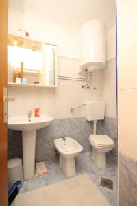 a bathroom with a toilet and a sink at Apartment Susak 8047a in Susak