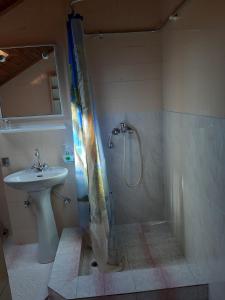 a bathroom with a shower and a sink at Apartments by the sea Mali Losinj (Losinj) - 7996 in Mali Lošinj