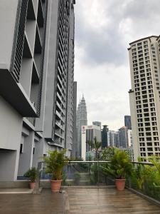 a view of the city from the balcony of a building at MyHabitat Residence Jalan Tun Razak in Kuala Lumpur