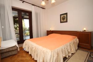 a bedroom with a bed and a large window at Apartments with WiFi Mali Losinj (Losinj) - 7992 in Mali Lošinj