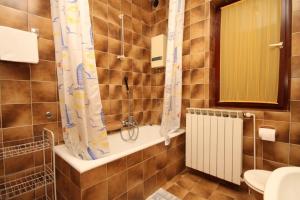 a bathroom with a shower and a toilet and a sink at Apartments by the sea Icici, Opatija - 7745 in Ičići