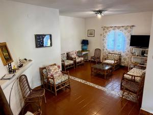 uma sala de estar com cadeiras e uma mesa em Villa fantastica Villasimius em Capitana