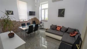 a living room with a couch and a table at Apartments with a parking space Opatija - 7868 in Opatija