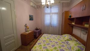 a small bedroom with a bed and a window at Apartments with a parking space Opatija - 7868 in Opatija