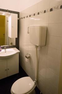 a bathroom with a white toilet and a sink at Apartments with a parking space Opatija - 7868 in Opatija +14 photos