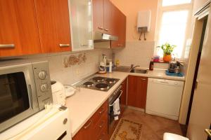a kitchen with a sink and a stove top oven at Apartments with a parking space Opatija - 7868 in Opatija
