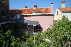 a house with a solarium on the side of it at Apartments by the sea Mali Losinj (Losinj) - 8001 in Mali Lošinj