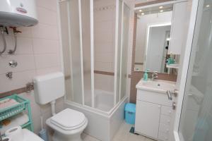 a bathroom with a shower and a toilet and a sink at Apartments with a parking space Opatija - 7896 in Opatija