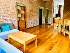 a living room with a table and a brick wall at Poe Luxury in Tartu