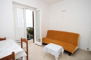 a living room with a couch and a table at Apartments with a parking space Icici, Opatija - 7988 in Ičići