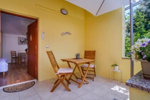 jadalnia z drewnianym stołem i krzesłami w obiekcie Apartments by the sea Artatore, Losinj - 7952 w mieście Čunski