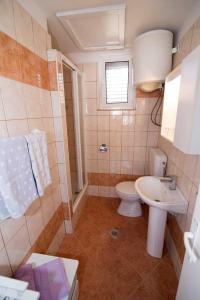 a small bathroom with a toilet and a sink at Apartments by the sea Veli Losinj, Losinj - 7959 in Veli Lošinj