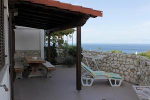 a patio with a table and chairs and a stone wall at Apartments with a parking space Mali Losinj (Losinj) - 7998 in Mali Lošinj