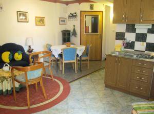 a kitchen and dining room with a table and chairs at Apartments by the sea Mali Losinj (Losinj) - 8002 in Mali Lošinj