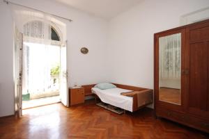 a bedroom with a bed and a large window at Apartments with a parking space Lovran, Opatija - 7693 in Lovran